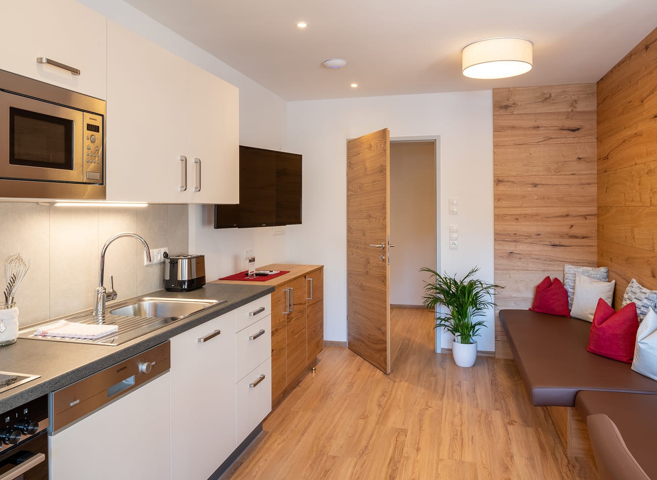 Offene Wohnk&uuml;che mit gem&uuml;tlichem Sitzbereich im Superior Appartement D2 f&uuml;r bis zu 8 Personen