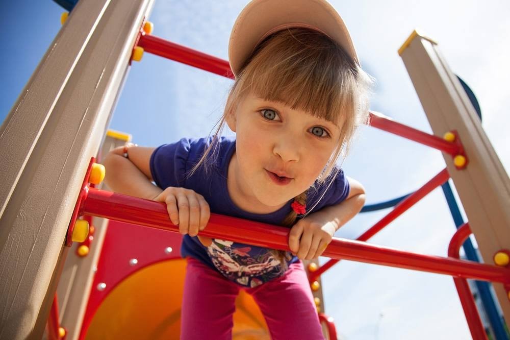Child playing on the playground at the Schattauer Apartments in Wagrain